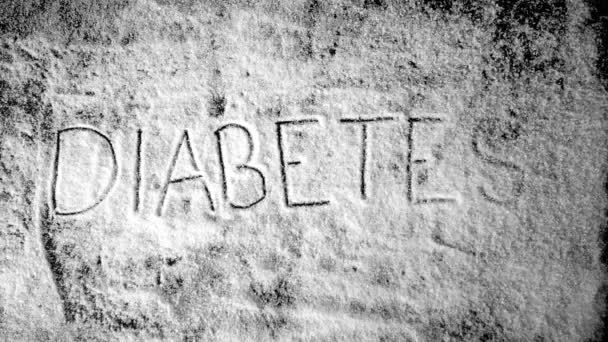 Diabetes escrita en polvo de azúcar que se sopla — Vídeo de stock