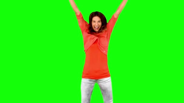 Mujer saltando con los brazos levantados en la pantalla verde — Vídeos de Stock