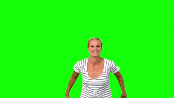 Blonde woman jumping against green screen — Wideo stockowe