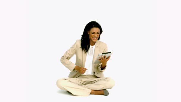 Woman cheering with her tablet on white background — Stock Video