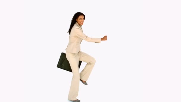 Businesswoman jumping with her suitcase — Stock Video