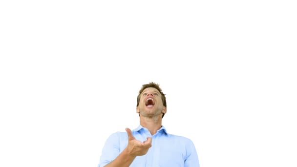 Man catching an orange segment with his mouth on white screen — Stock Video