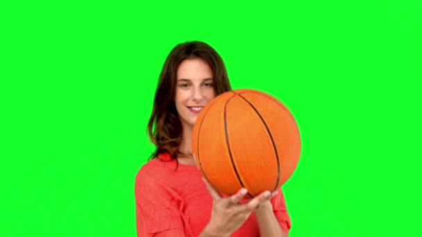 Woman having fun with a basket ball on green screen — Stock Video