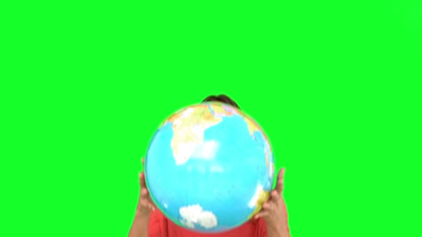 Woman throwing a globe in the air on green screen — Stock Video