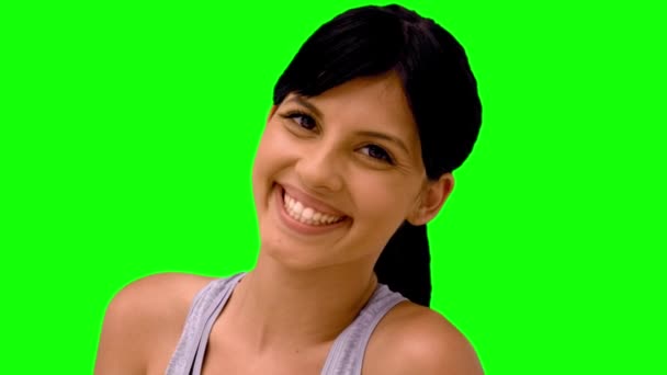 Athletic woman smiling at camera on green screen — Stock Video