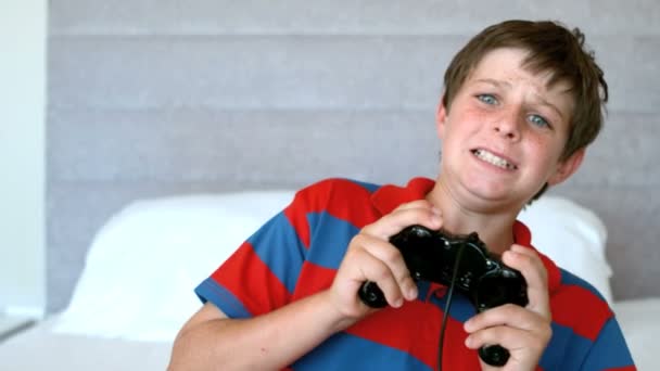 Concentrated young boy playing video games — Stock Video