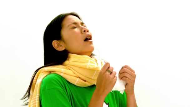 Asian woman in green tshirt and yellow scarf sneezing — Stock Video