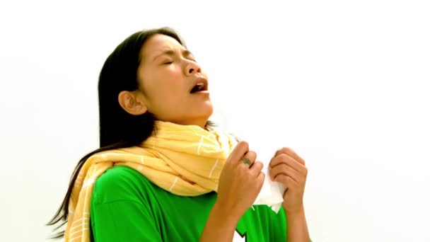 Asian lady in green tshirt and yellow scarf sneezing — Stock Video