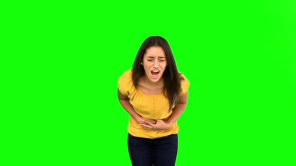 Woman suffering from belly pain on green screen — Wideo stockowe