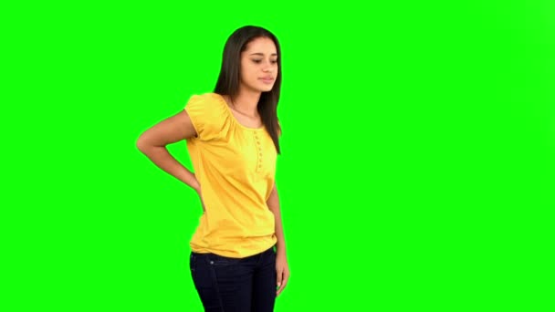 Woman rubbing painful back on green screen — Stock Video