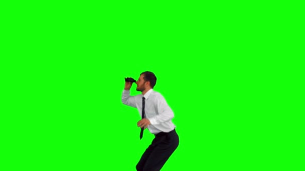 Businessman looking through binoculars while jumping up — Stock Video
