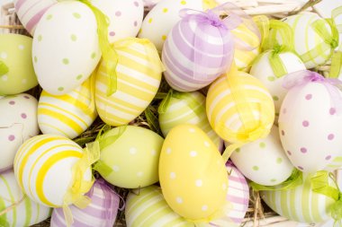 Colourful easter eggs in straw clipart