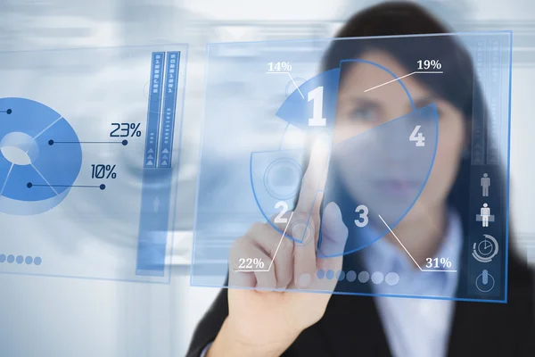 Serious businesswoman using blue pie chart futuristic interface — Stock Photo, Image