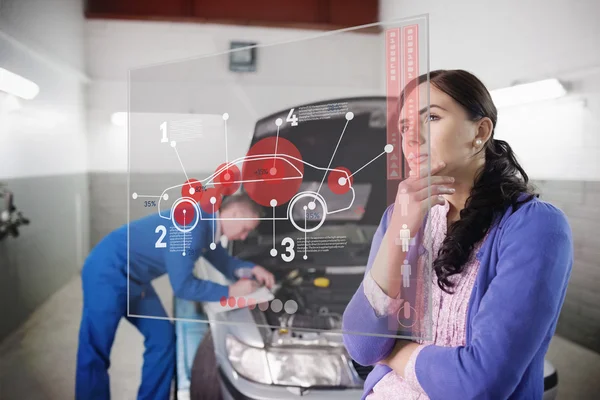 Auto mechanik se zákazníkem při pohledu na futuristické rozhraní — Stock fotografie