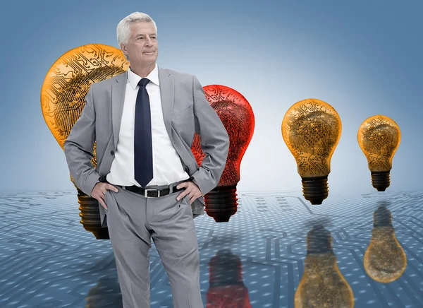 Businessman in front of colored light bulbs — Stock Photo, Image