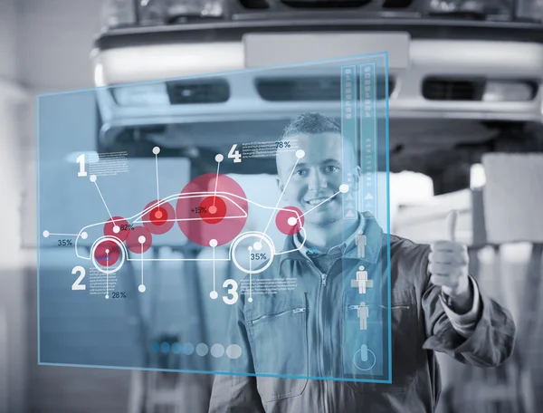 Portrait of smiling mechanic thumbs up with futurist interface i — Stock Photo, Image