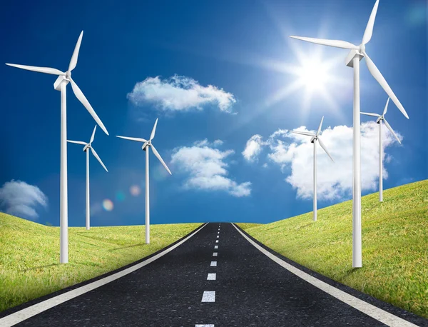 Road leading out to the horizon with wind turbines either side — Stock Photo, Image