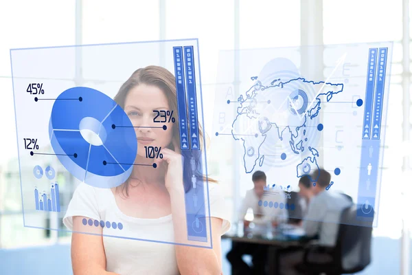 Smiling businesswoman looking at blue pie chart interface — Stock Photo, Image