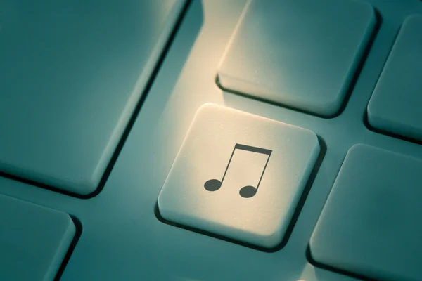 Black music note button on keyboard — Stock Photo, Image
