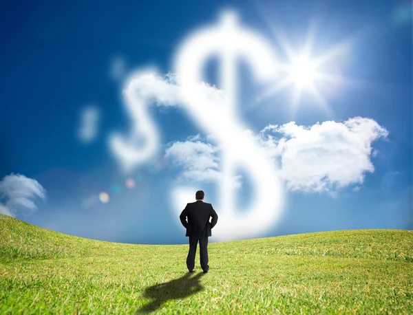 Businessman looking at cloud dollar signs — Stock Photo, Image