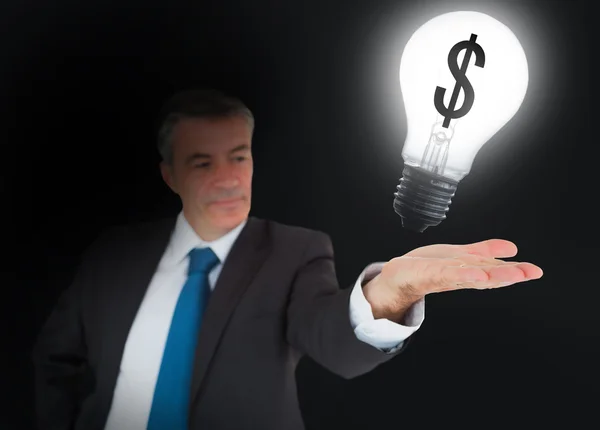 Businessman showing light bulb — Stock Photo, Image