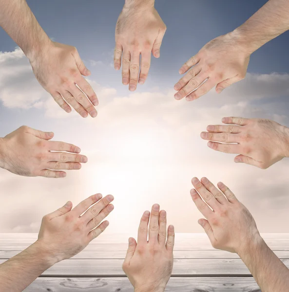 Group of hands forming a circle over blue sky — Stock Photo, Image