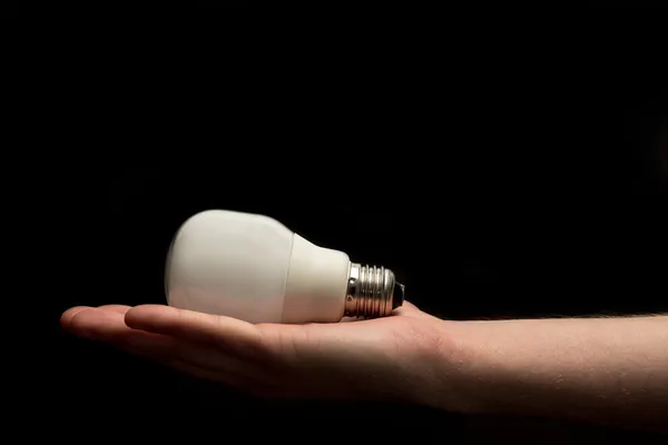 Hand holding white economic light bulb — Stock Photo, Image