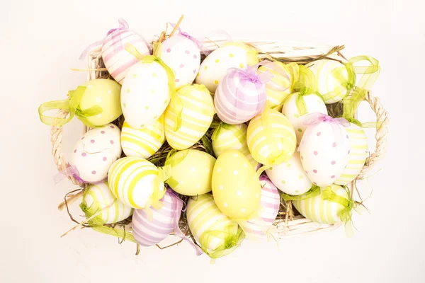 Colourful easter eggs in basket — Stock Photo, Image