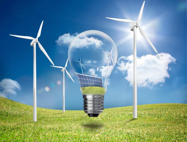 Light bulb showing solar panels and turbines in a field with win — Stock Photo, Image