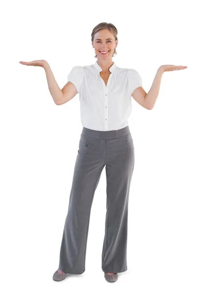 Smiling businesswoman presenting something with her two hands raised — Stock Photo, Image