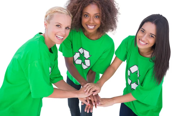 Three enviromental activists putting their hands together and smiling — Stock Photo, Image