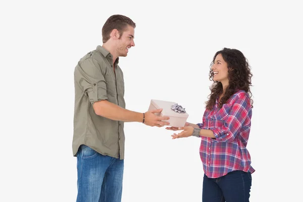 Man offering his friend a present — Stock Photo, Image