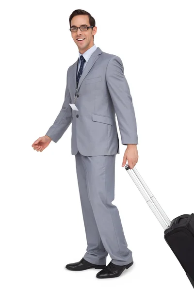 Smiling businessman walking with his suitcase — Stock Photo, Image