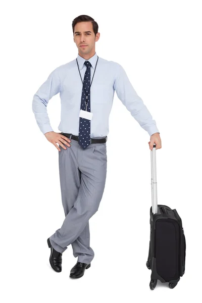 Serious businessman next to his suitcase — Stock Photo, Image