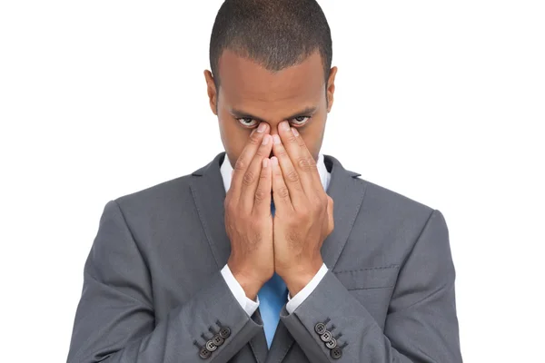 Young businessman holding his head between hands — Stock Photo, Image