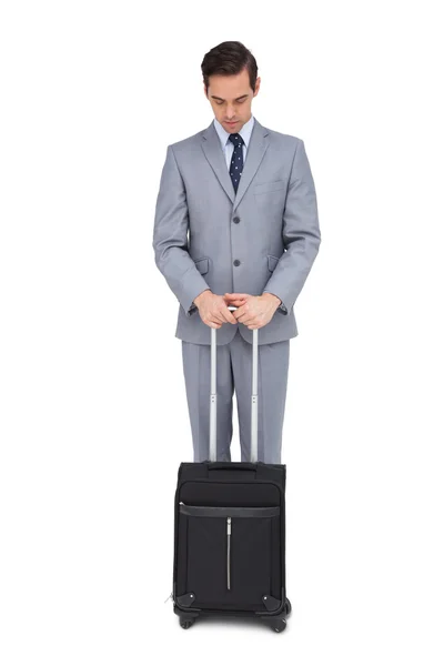 Serious young businessman waiting with his suitcase — Stock Photo, Image