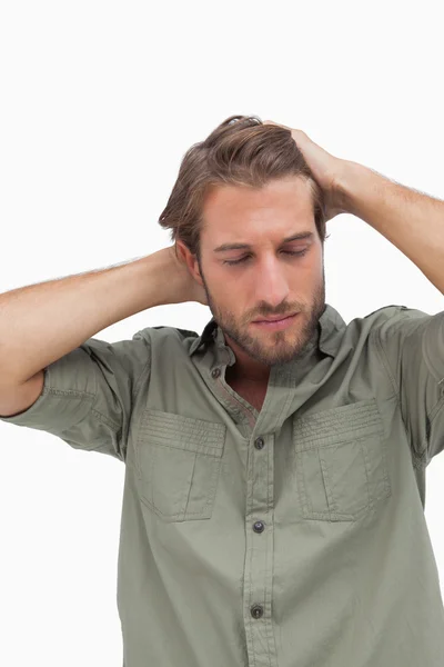 Stressed man looking down with hands on head — Stock Photo, Image