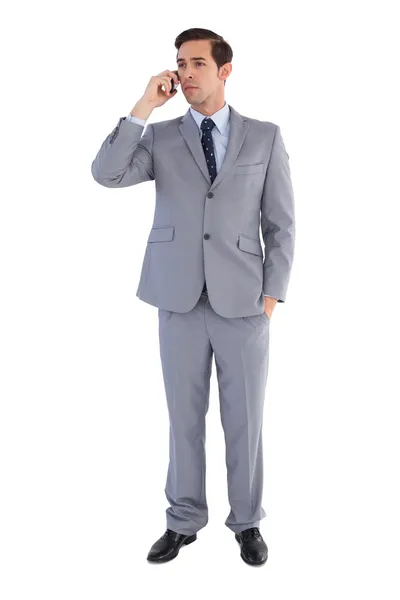 Serious business standing while he is on the phone — Stock Photo, Image