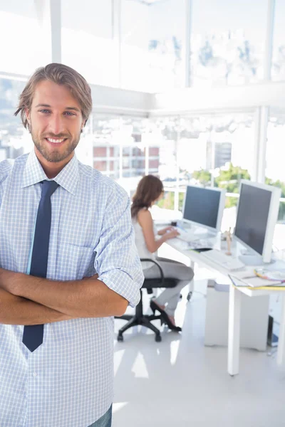 Smiling desginer standing in office with arms crossed — Stock Photo, Image