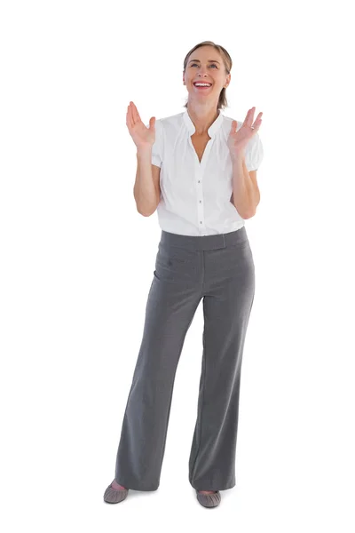 Cheerful businesswoman standing with raised hands — Stock Photo, Image
