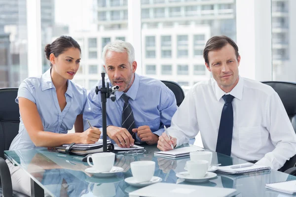 Businessman speaking in a microphone — Stock Photo, Image