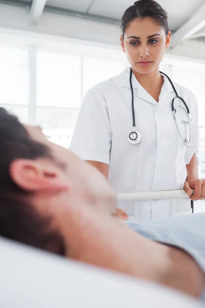 Serious nurse taking care of a patient — Stock Photo, Image