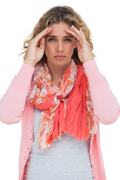 Blonde woman touching her temples because of a headache — Stock Photo, Image