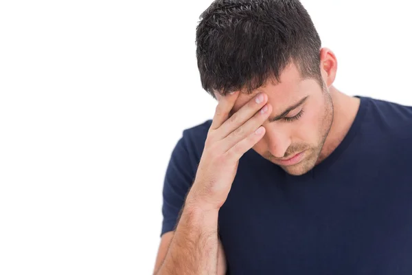 Upset man standing with his hand holding his forehead — Stock Photo, Image