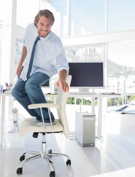 Man surfing his office chair — Stock Photo, Image