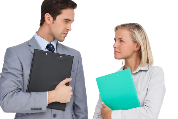 Serious business looking at each other with folders — Stock Photo, Image