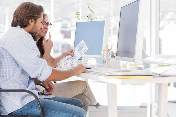 Editors going over the contact sheet — Stock Photo, Image