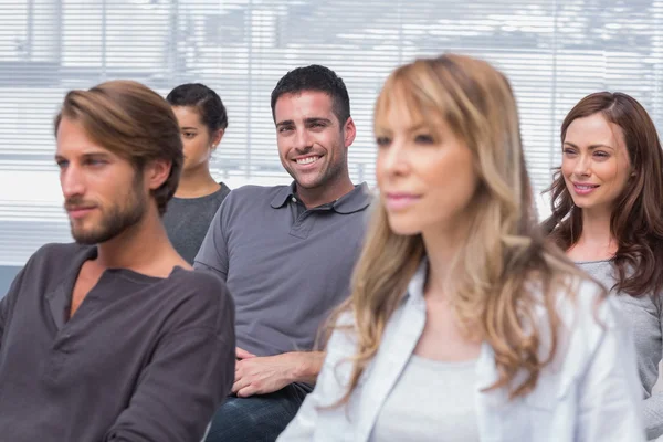 Patients listening in group therapy with one man smiling — Stock Photo, Image