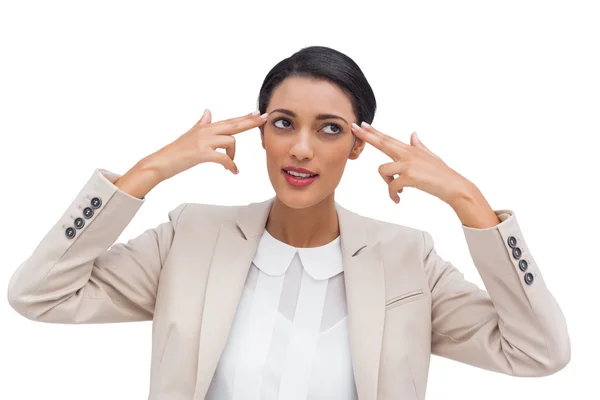 Confident businesswoman pointing her head with her fingers — Stock Photo, Image