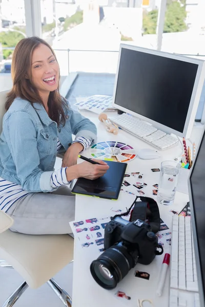Laughing photo editor working with a graphic tablet — Stock Photo, Image